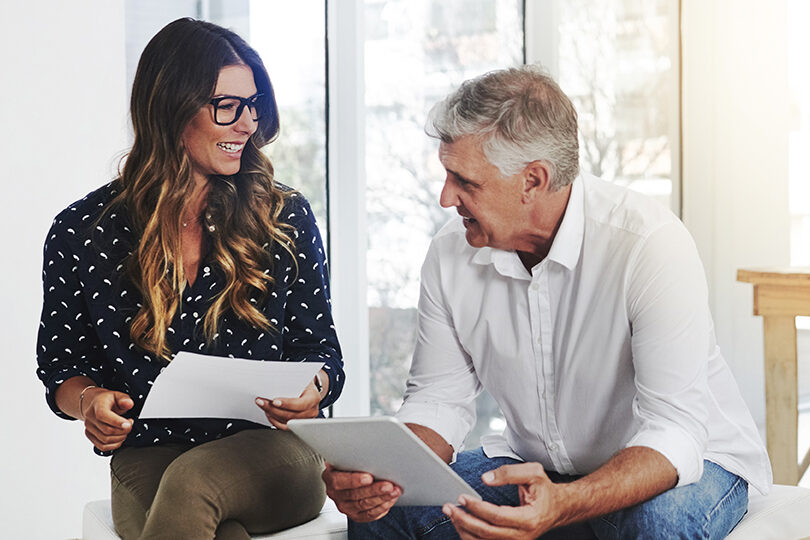 Tablet, discussion and mentor with woman talking in office for business proposal, strategy or advice. Collaboration, teamwork and corporate managers meeting for project, report document or review