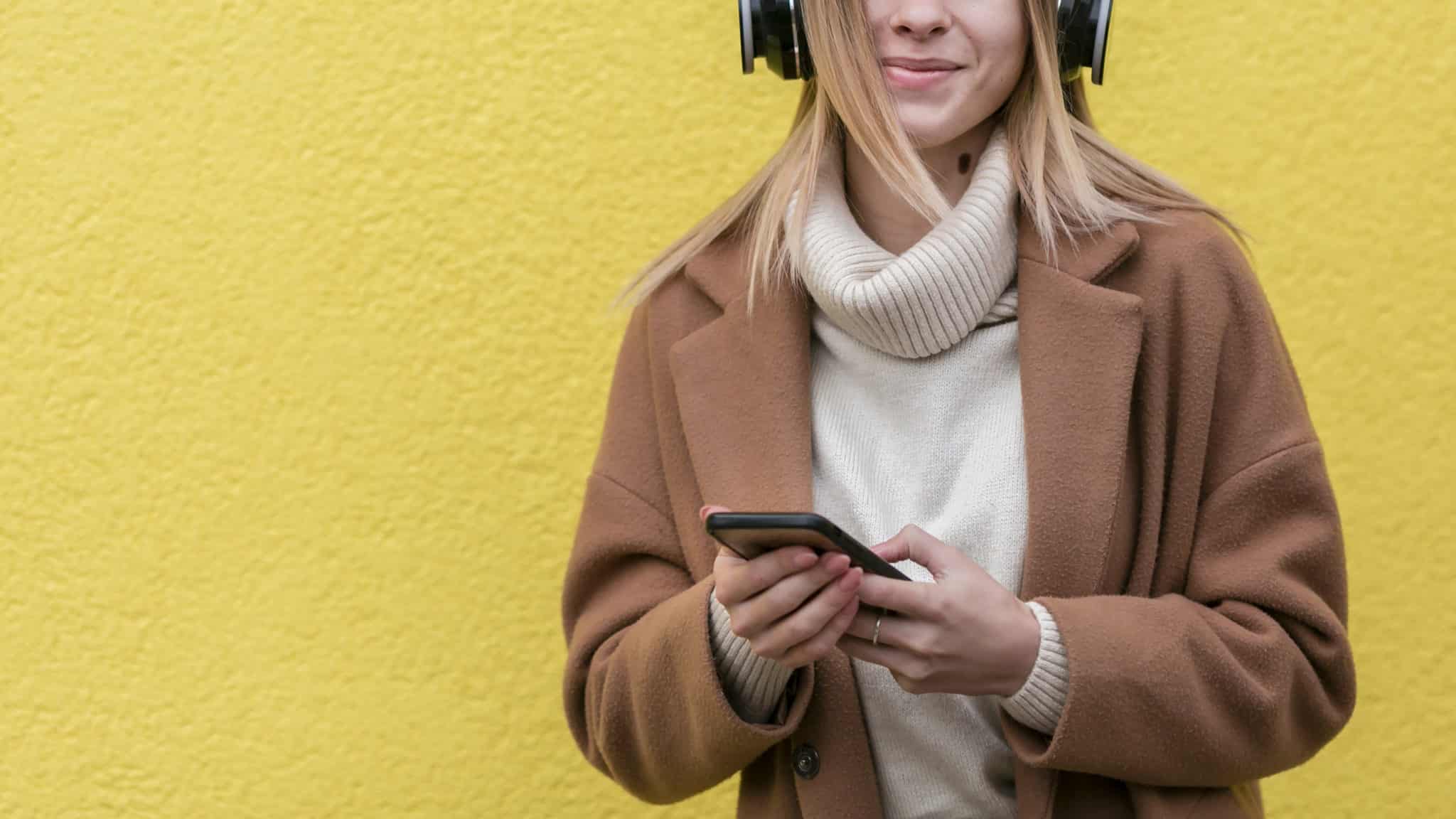 young-woman-enjoying-music-her-headphones-with-copy-space